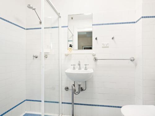 a bathroom with a sink and a shower at Lord Wolseley Hotel in Sydney