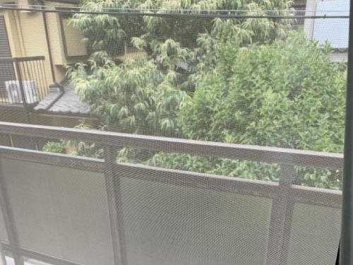 a view of a balcony with plants on it at Imazato Ryokan in Osaka