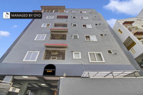 a tall grey building with windows on the side at Super Townhouse HAL Indiranagar Extension in Bangalore