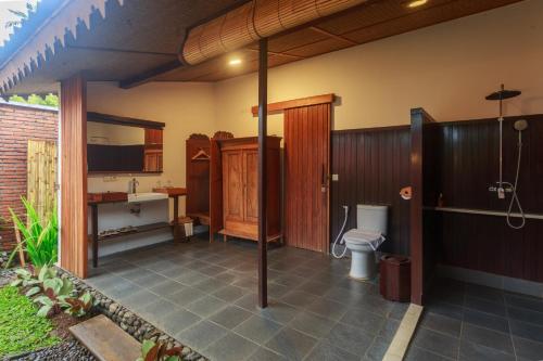 ein Bad mit einem WC und einem Waschbecken in der Unterkunft Villa So Long Banyuwangi - Ijen in Banyuwangi