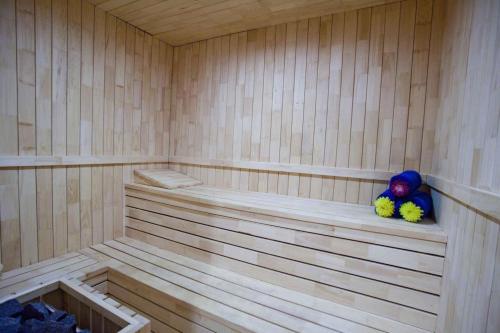 a sauna with two stuffed animals sitting on a shelf at Aryaduta Makassar in Makassar