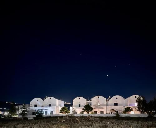 a group of white buildings at night at Sun Springs Suites in Kamari
