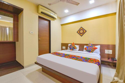 a bedroom with a large bed in a room at FabHotel RB Residency in Surat