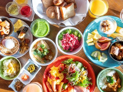 a table with many plates of food on it at The Luigans Spa and Resort in Fukuoka