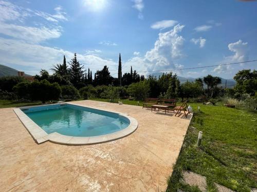 a small swimming pool in a yard with a bench at Villa con piscina in Castellammare del Golfo
