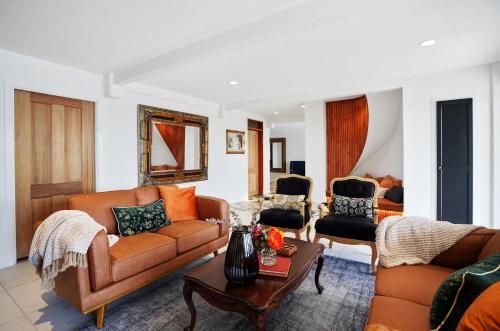 a living room with two couches and a table at Maleny Country Estate in Maleny