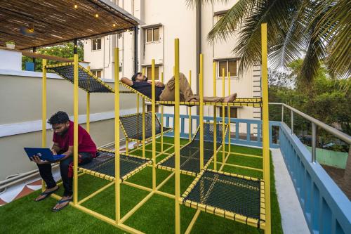 a group of people sitting on a playground at Zostel Visakhapatnam (Vizag) in Visakhapatnam