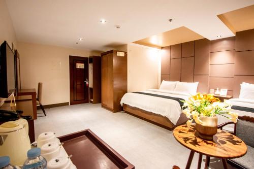 a hotel room with a bed and a table at ECL Resort Hotel Boracay in Boracay