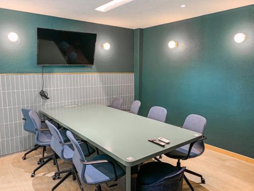 a conference room with a table and chairs at Mr A Hotel in Bandung