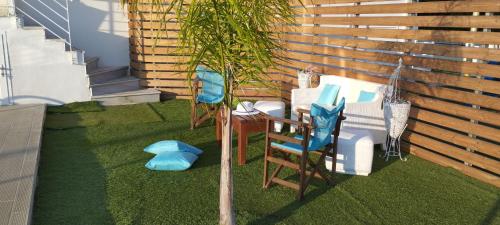 a miniature garden with chairs and a table and a plant at Le petit luxury apartment in Preveza