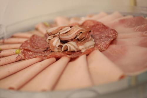 a plate of food with meat and cheese at Garni Hotel Torkelbündte in Bad Ragaz