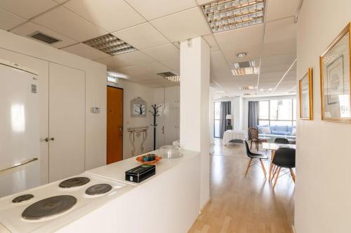 a kitchen and living room with a stove at Downtown Spacious Loft Apartment just 3 minutes from City Centre in Heraklio Town
