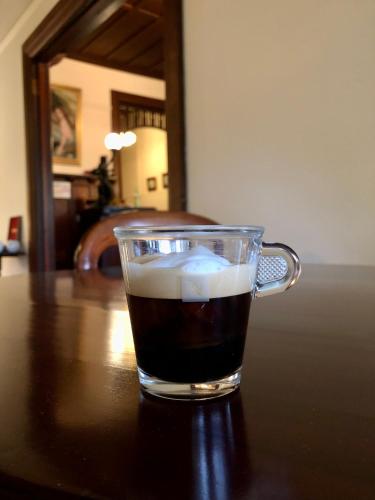 a glass cup of coffee sitting on a table at Lorelei Bed & Breakfast in Portland