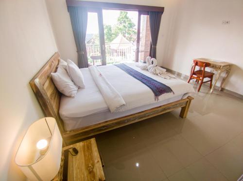 a bedroom with a large bed with a window at The Lucky Canggu in Canggu