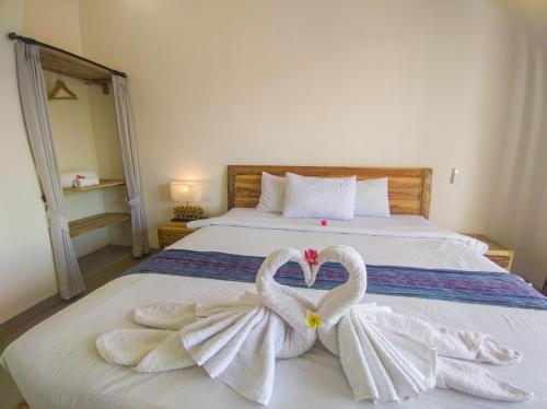 two swans making a heart on a bed at The Lucky Canggu in Canggu