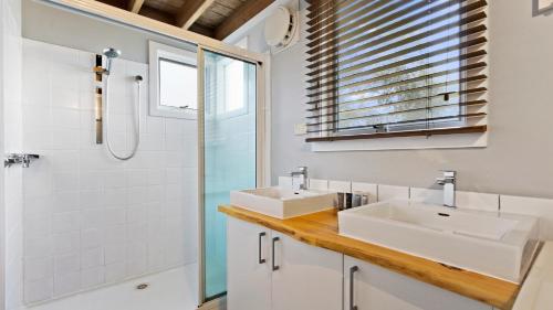 a bathroom with two sinks and a shower at Paddys in Dinner Plain