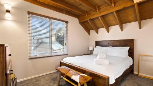 a bedroom with a bed and a window at Paddys in Dinner Plain