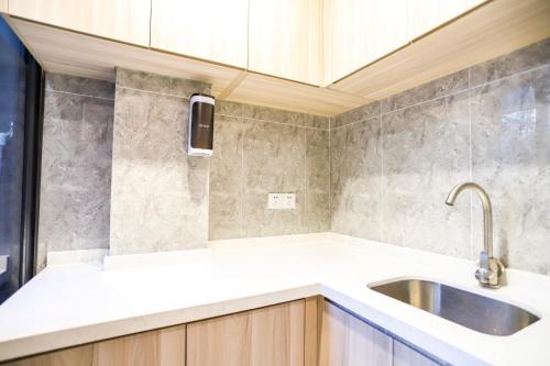 a kitchen with a sink and a counter top at Shenzhen B T Miele Executive Apartment - Baoan International Airport Bihaiwan Subway Station in Shenzhen