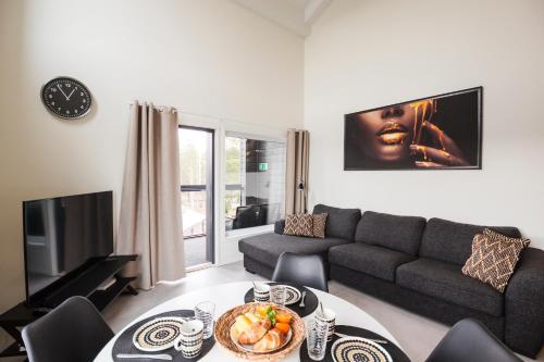 a living room with a couch and a table at Hilmantori Apartments by Hiekka Booking in Kalajoki