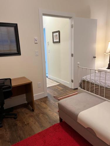 a bedroom with a bed and a desk and a desk at Furnished and Cozy in Surrey