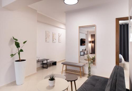 a living room with a couch and a table at Peratzada apartments in Vasiliki