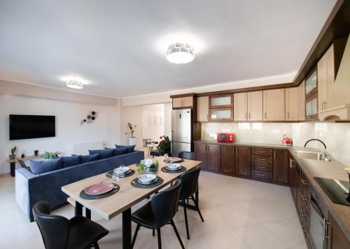 a kitchen and living room with a table and chairs at Peratzada apartments in Vasiliki