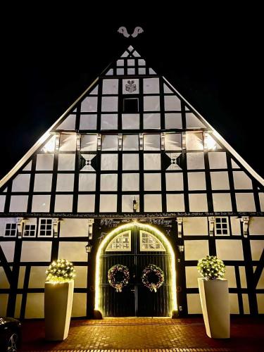 a large black and white building with a door at DRIEHOF LifeStyle Suite Apt 1 in Tecklenburg