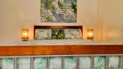 a bedroom with a bed with two lights on it at Villa Agata Mauritius in Mont Choisy