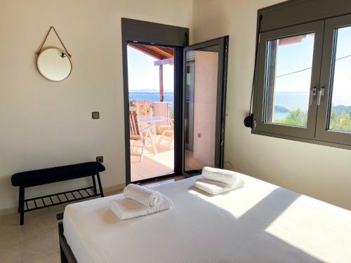 a bedroom with a bed and a view of a patio at ArtView Villa in Syvota