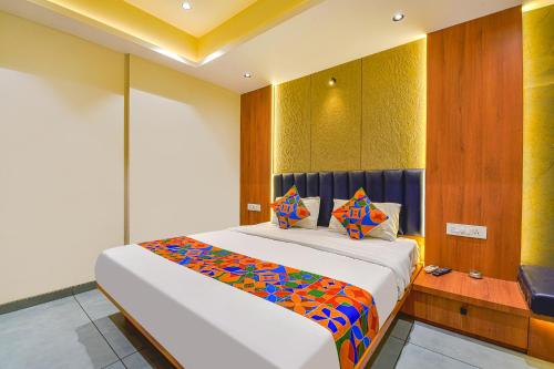a bedroom with a large bed in a room at FabHotel Udhna Inn, Near Udhna Junction in Surat