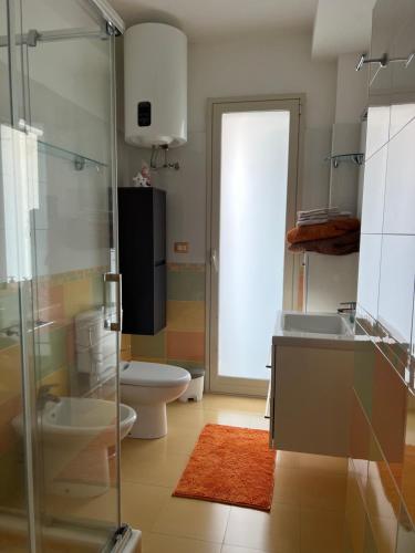 a bathroom with a toilet and a sink and a shower at Sweet Dream in Acitrezza