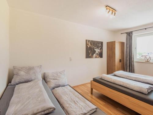 a bedroom with two beds and a window at Beautiful apartment in Hart im Zillertal with mountain view in Hart im Zillertal