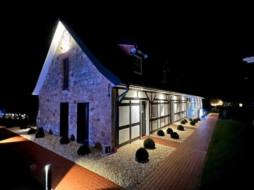 a stone building at night with plants in front of it at DRIEHOF LandGut & Residenz LifeStyle Suite Apt 6 in Tecklenburg