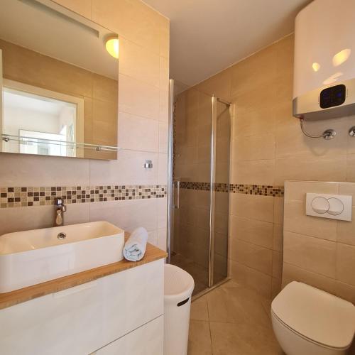 a bathroom with a sink and a toilet and a shower at The View in Vinišće