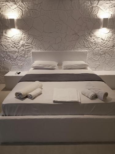 a bedroom with two beds with towels on them at Traditional house under the castle in Astypalaia Town