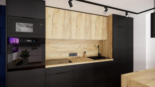 a kitchen with black appliances and wooden cabinets at RestPark in Kielce