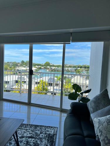 a living room with a view of a balcony at Marina View Holiday Apartment - Beautiful Views in Larrakeyah