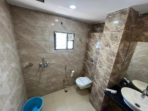 a bathroom with a shower and a toilet and a sink at Hotel Pratap Residency-With early check inn in Rānchī