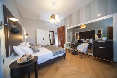 a hotel room with a bed and a dining room at Hotel Grande Italia in Chioggia