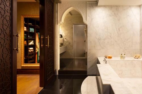 a bathroom with a sink and a shower at Jumeirah Zabeel Saray Dubai in Dubai