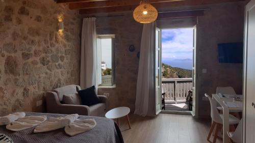 a bedroom with a bed and a view of a balcony at Palma resorts in Nikiá