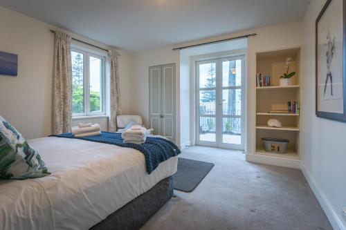 a bedroom with a bed with two towels on it at Sumner Surf Break Apt 2 in Christchurch