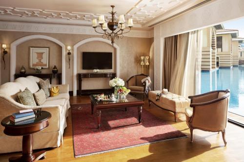 a living room with a couch and a table at Jumeirah Zabeel Saray Dubai in Dubai
