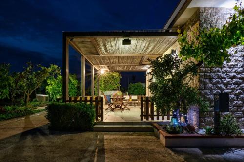 a stone house with a patio at night at Casa vacanze "Ulivi nel Mare" in Sciacca