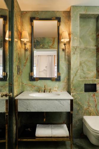 a bathroom with a sink and a mirror and a toilet at The Serangoon House Little India, Singapore, a Tribute Portfolio Hotel in Singapore