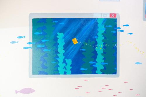 an underwater picture of a reef with fish and a yellow box at 自由自在OSU 402(KUMO) in Nagoya