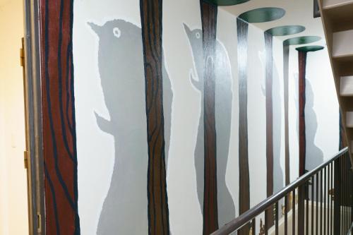 a wall mural of cats on a staircase at 自由自在OSU 402(KUMO) in Nagoya