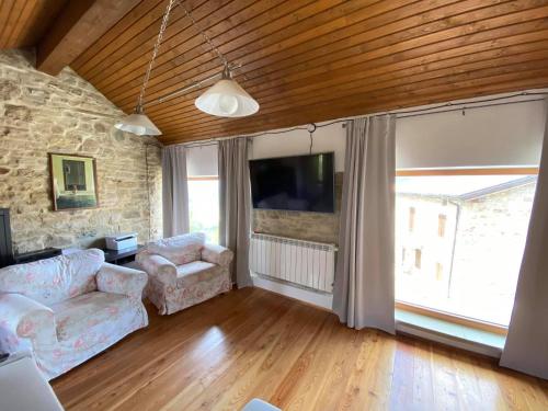 a living room with a couch and a tv at Casa Tincana in Bebbio