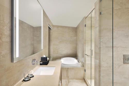 a bathroom with a toilet and a glass shower at Courtyard by Marriott Nashik in Nashik
