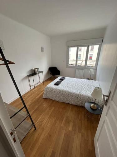 une chambre blanche avec un lit et un parquet dans l'établissement Grand Cru * Magnifique Duplex au cœur d’Epernay, à Épernay